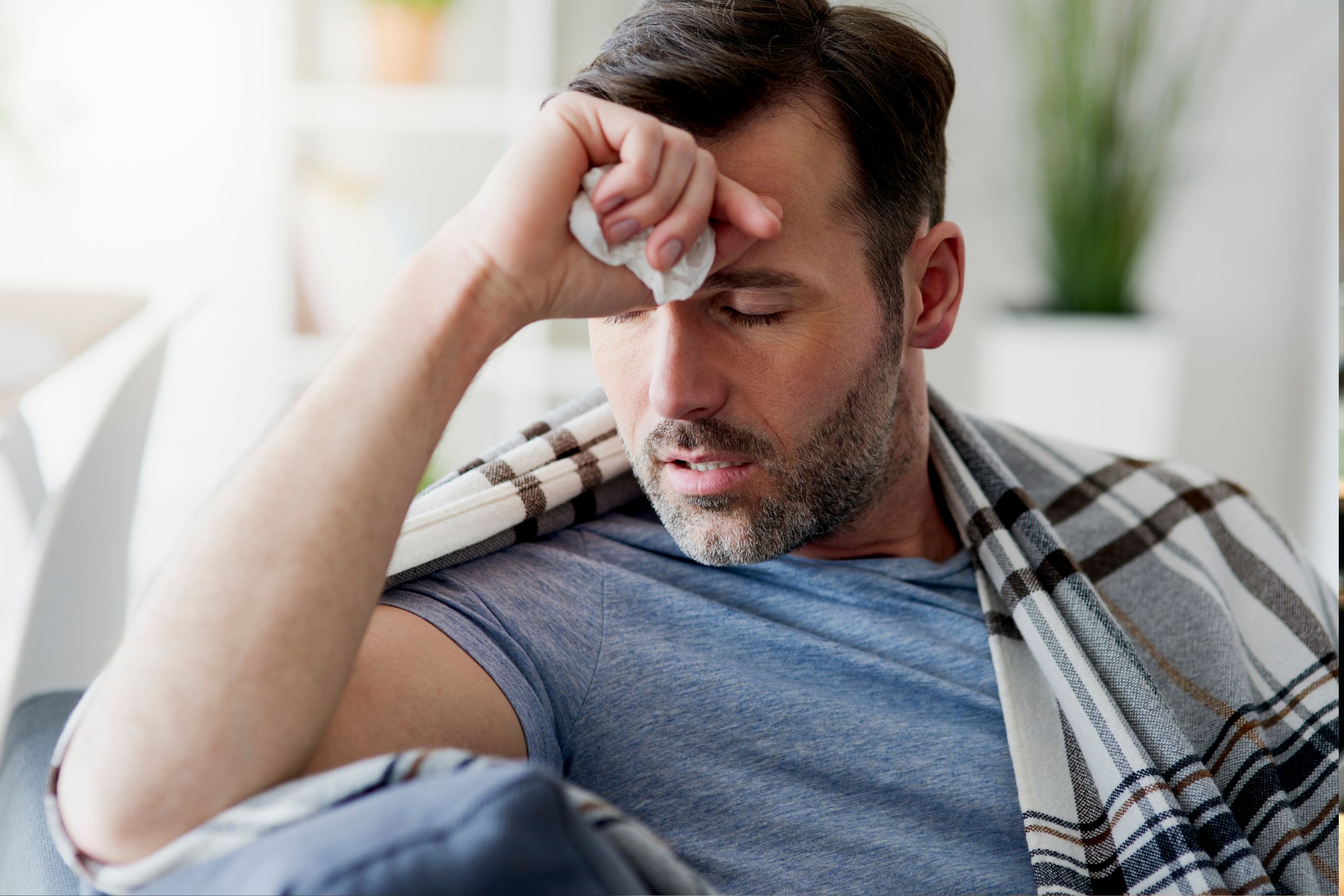 man sick on the couch trying quit drinking cold turkey