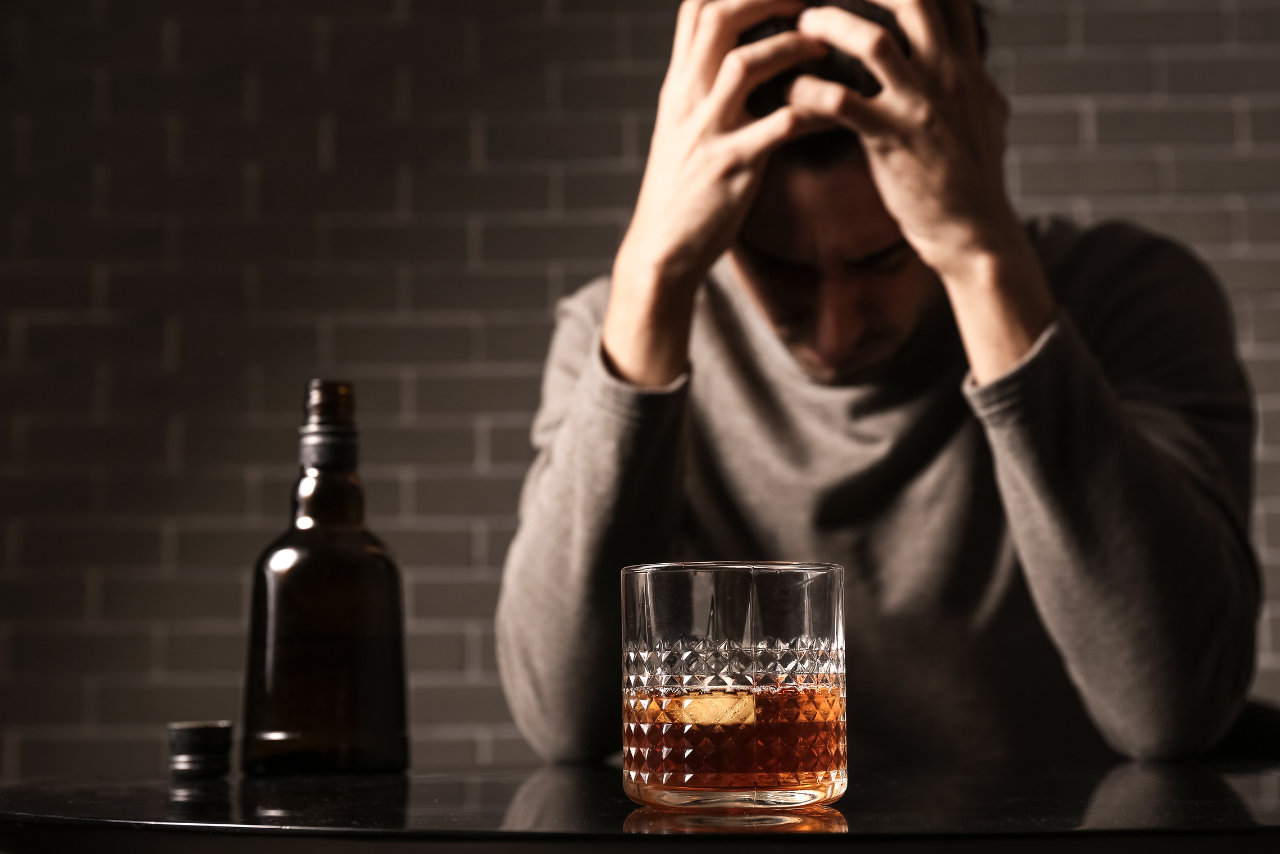 man struggling with alcohol addiction wondering what causes alcohol withdrawal seizures