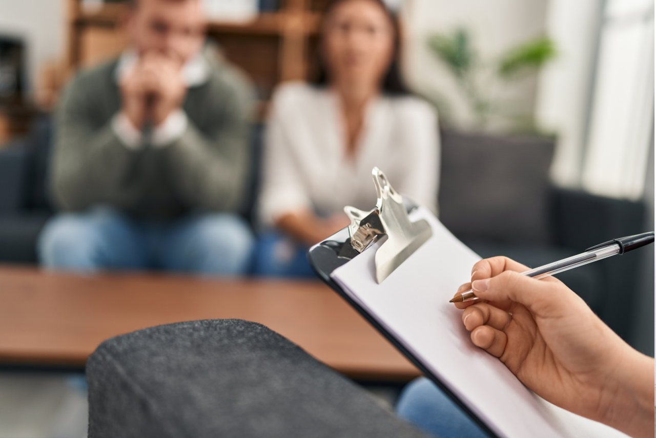 husband and wife speaking with therapist about how to deal with husband addiction