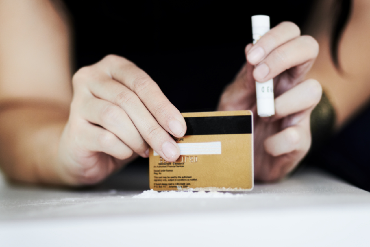 man sitting at the table making lines of pink cocaine wondering what is pink cocaine