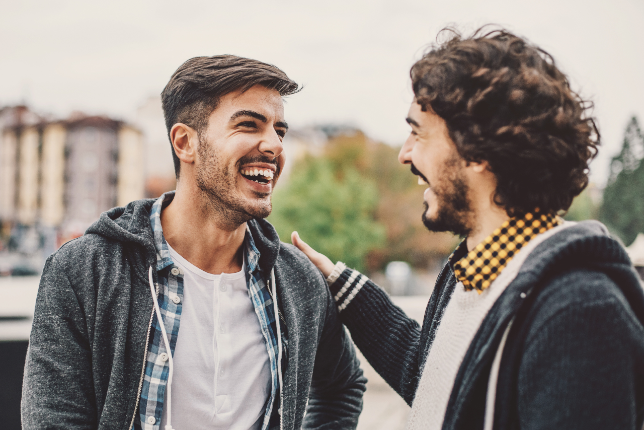 two men smiling very happy after finding out What is PHP Therapy vs IOP